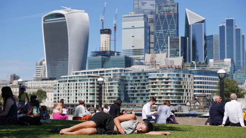 People enjoy the warm weather in Potters Fields Park in London (Lucy North/PA)