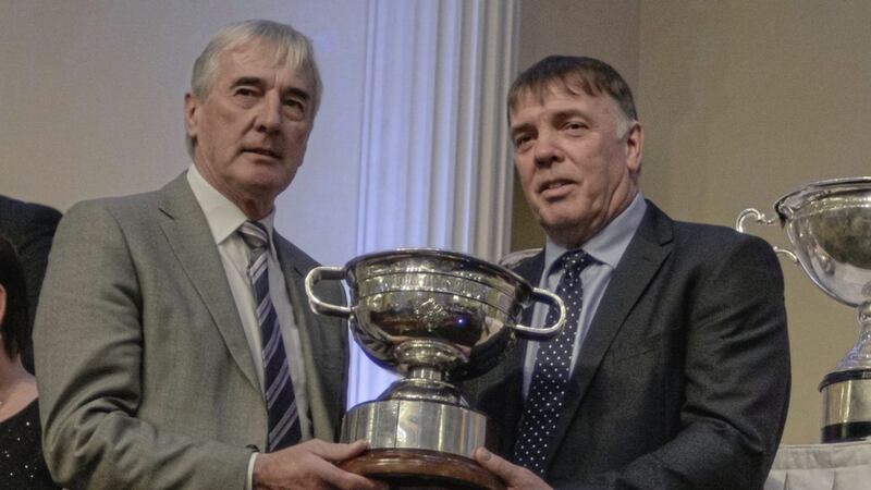 A decade of support: pictured at the recent Derry GAA prize-giving at Tullyglass Hotel, Ballymena are former Derry stars Mickey Lynch (right) and John Joe Kearney. Kearney, assistant manager of Derry and Ulster senior football champions, Slaughtneil, accepts the John McLaughlin Cup on behalf of the Robert Emmet&#39;s club from Lynch, co-founder of M&amp;L Contracts, sponsors of the Derry SFC for the past decade.  