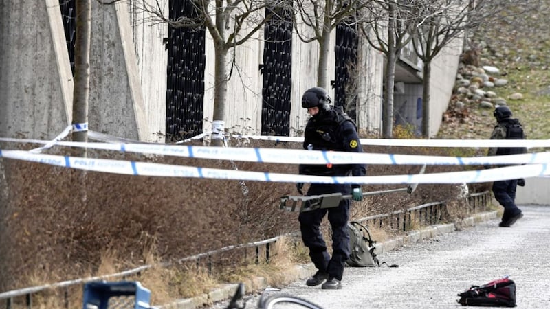Swedish police search the area outside Varby Gard metro station, in Stockholm, near to where two people were injured by some kind of explosion, on Sunday. Picture by Henrik Montgomery, TT via Associated Press 
