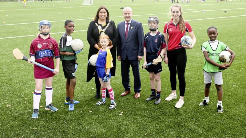 School children, Anna McCaldin, Keith Ncube, Sara Kelly, Conor MacElhatton, Beth Deeney and Matipa Njanina, help Lord Mayor, Councillor Deirdre Hargey and Michael Hasson, President of Ulster GAA, celebrate the opening of new pitches at Cherryvale playing fields on the Ravenhill Road in east Belfast. The opening marks the completion of Belfast city council&#39;s pitches strategy, a &pound;15 million investment, in playing and changing facilities at 10 sites across the city. The council invested &pound;14 million, while the GAA invested &pound;1.4 million 