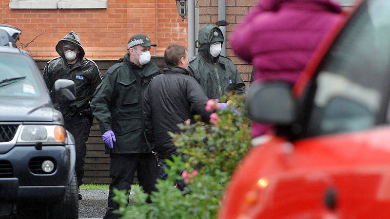 A PSNI specialist search team at the house where the bodies were discovered 