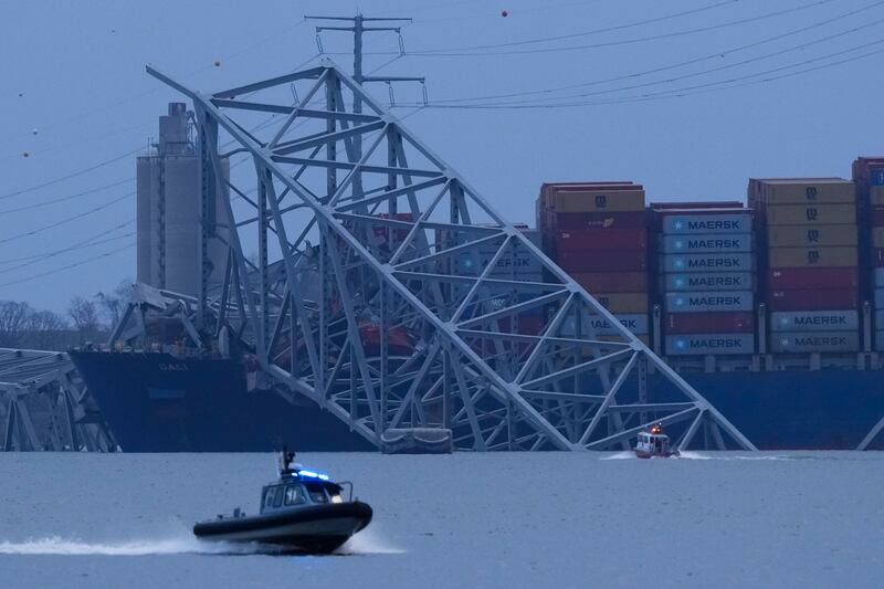 The wreck of the Francis Scott Key Bridge as night falls on Tuesday (Matt Rourke/AP)