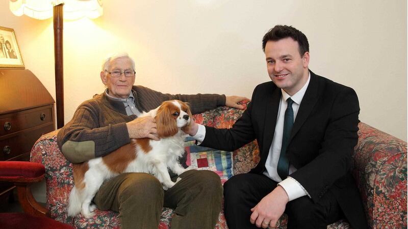 Former Deputy First Minister Seamus Mallon and SDLP leader Colm Eastwood with Jessie, Mr Mallon's King Charles Spaniel in 2015. Picture by Cliff Donaldson&nbsp;
