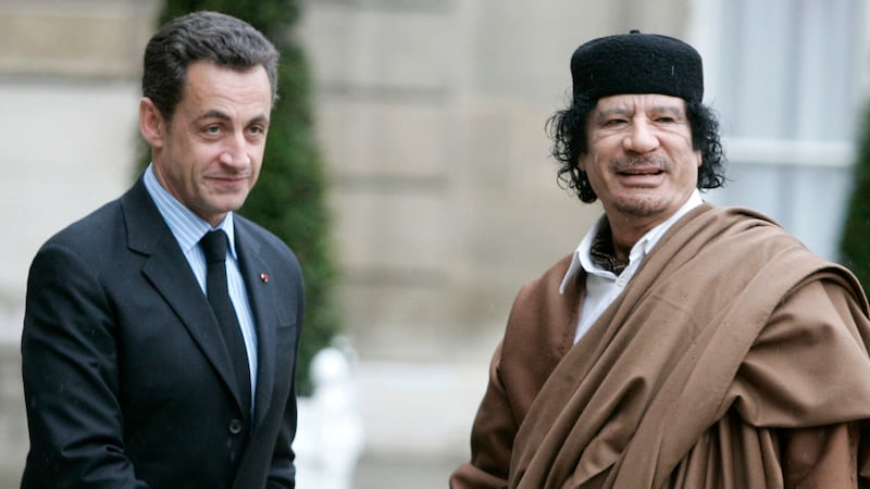 Nicolas Sarkozy greets Libyan leader Col Muammar Gaddafi upon his arrival at the Elysee Palace, in Paris in December 2007 (AP)