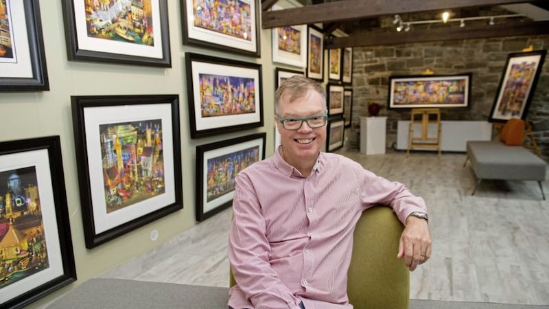 Artist Keith Drury with some of his distinctive cityscape paintings in his studio in Crossgar, Co Down Picture: Mark Marlow 