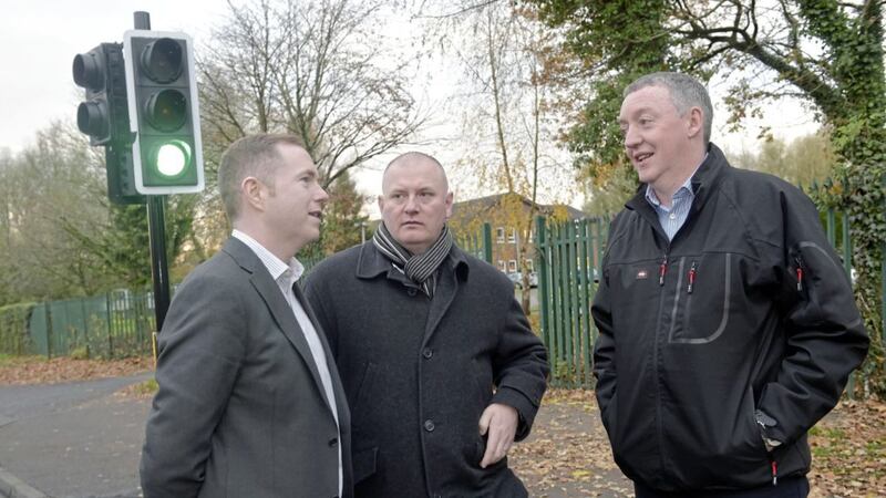 Infrastructure Minister Chris Hazzard pictured with councillor Stephen Magennis and community safety worker for Colin Neighbourhood Partnership, Michael George at the traffic signal at Bellsteel/Glenwood. Picture by Simon Graham/Harrison Photography 