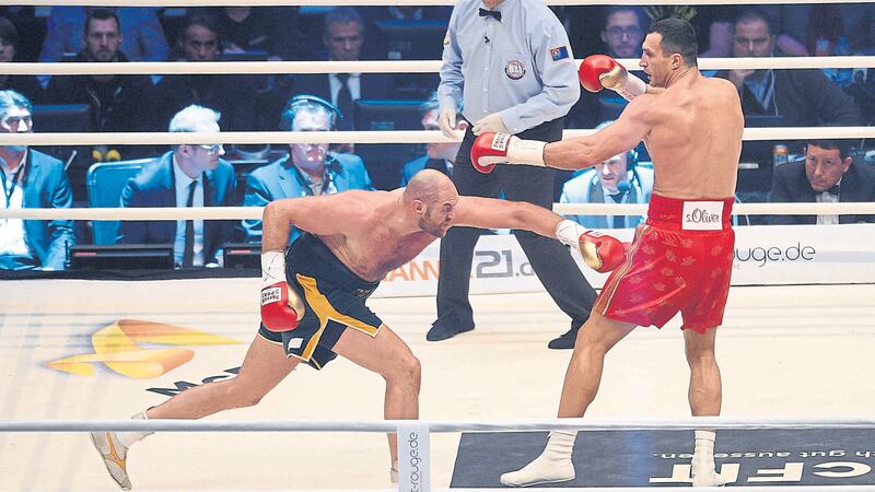 Wladimir Klitschko (right) and Tyson Fury exchange blows in their world heavyweight title fight for Klitschko's WBA, IBF, WBO and  IBO belts in the Esprit Arena in Duesseldorf on Saturday November 28 2015