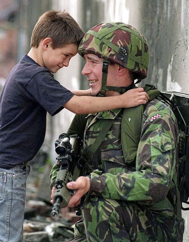 A young boy and soldier on the Springfield Road in west Belfast. Picture by Pacemaker