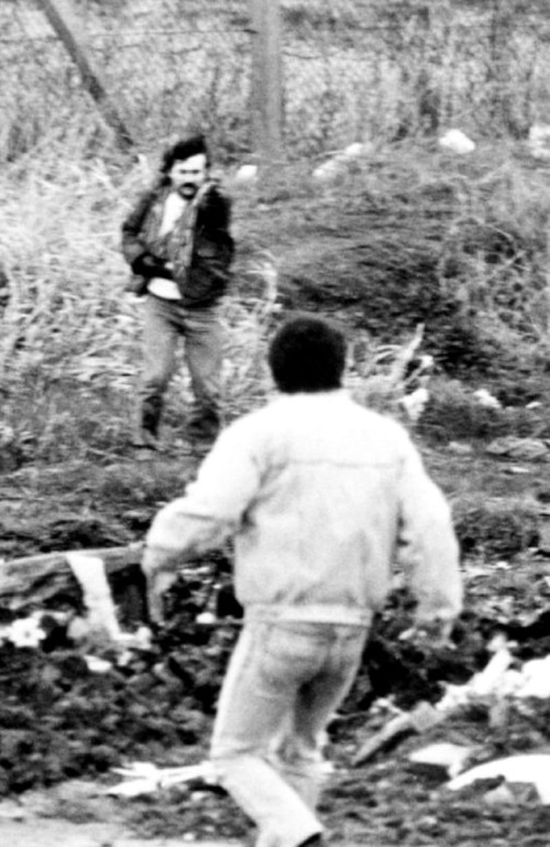 &nbsp;Michael Stone brandishing a pistol in Milltown Cemetery after a gun and grenade attack on mourners at a funeral of three IRA terrorists 1988