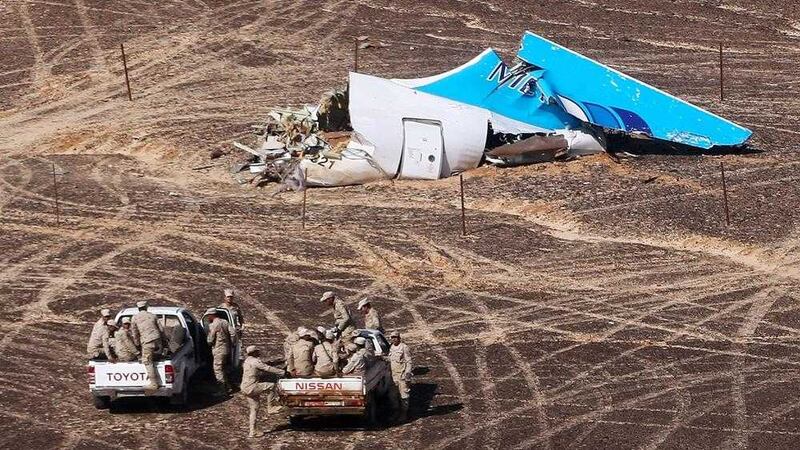 CRASH: Egyptian Military approach a plane&#39;s tail at the wreckage of a passenger jet bound for St Petersburg in Russia that crashed in Hassana, Egypt, on Sunday. The Russian cargo plane on Monday brought the first bodies of Russian victims killed in a plane crash in Egypt home to St Petersburg, a city awash in grief for its missing residents. PICTURE: Maxim Grigoriev/Russian Ministry for Emergency Situations via AP 