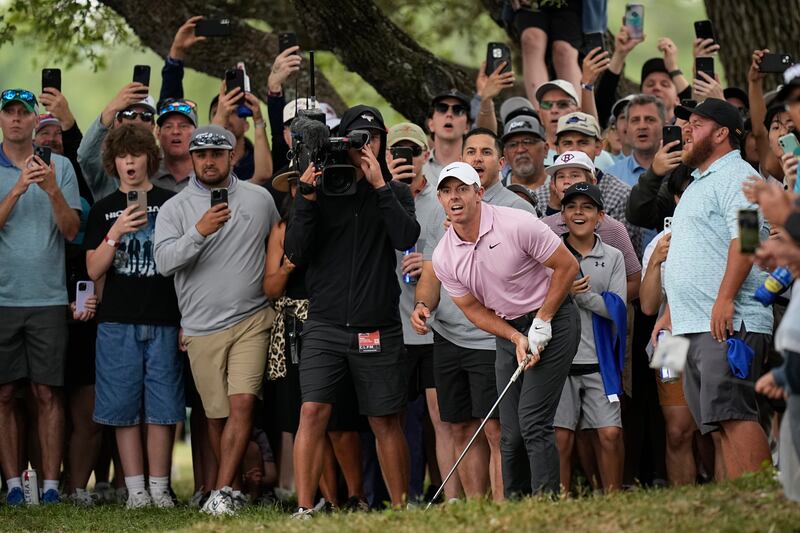 Rory McIlroy and fans react to his shot from the rough on the eighth hole during the third round of the Texas Open (Eric Gay/AP)