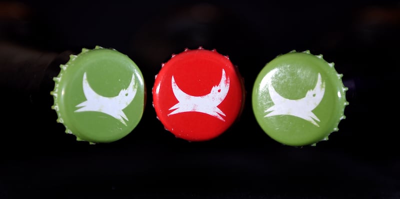 Bottle tops of Brewdog's Dead Pony Pale Ale and Five AM Red Ale showing the company's logo, as the craft beer company is to expand with the creation of 130 jobs.