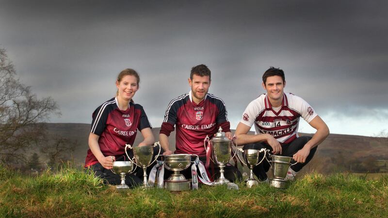 At the foot of Carntogher Mountain, Slaughtneil GAC's historic triple Ulster Senior Championship captains, Aoife Ni Chaiside, Francis McEldowney and Chrissy McKaigue with the silverware as Derry and Ulster Champions. Picture by Margaret McLaughlin&nbsp;