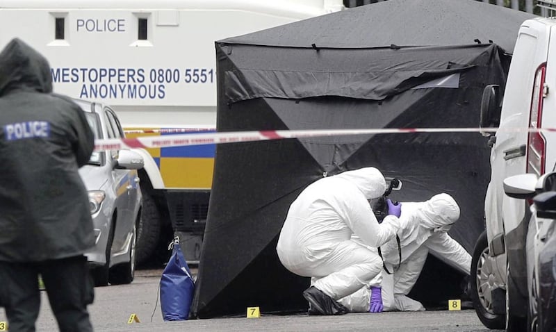 Forensic officers at the scene where Warren Crossan was shot dead in the St James&#39; area of Belfast. Picture by Hugh Russell 