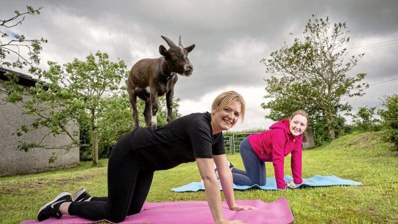 Wendy Gallagher and her daughter, Lucy take part in goat yoga at Castlescreen Farm in Downpatrick, Co Down 