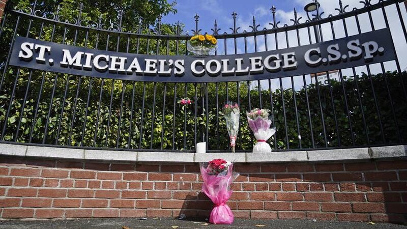 Flowers outside St Michael’s College in Dublin after the deaths of two recent graduates on the Greek island of Ios (Niall Carson/PA)