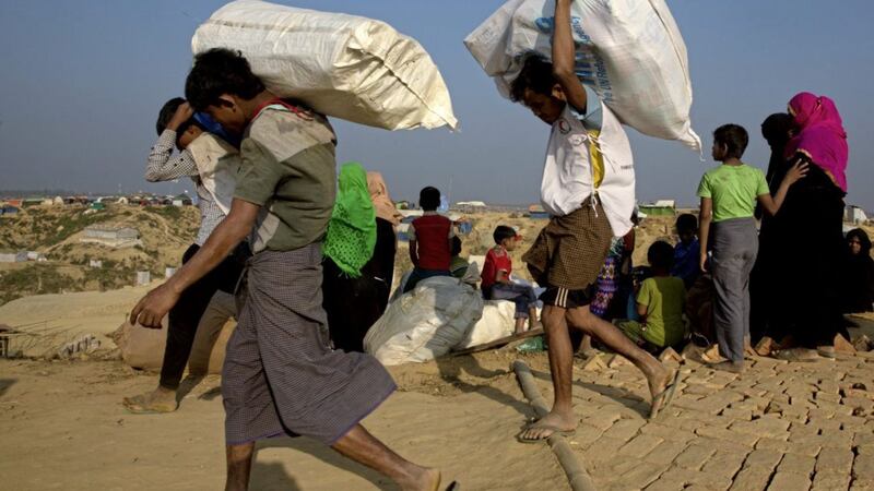 Rohingya Muslim refugees staying in no-man&#39;s land at Bandarban between Myanmar and Bangladesh border arrive at a refugee camp in January 