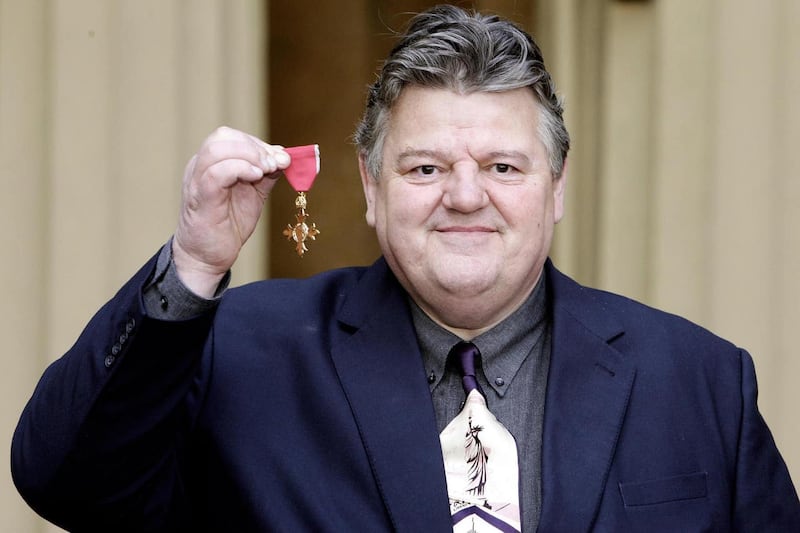 Actor Robbie Coltrane with his OBE after receiving it from the Queen at Buckingham Palace, London, on March 2 2006