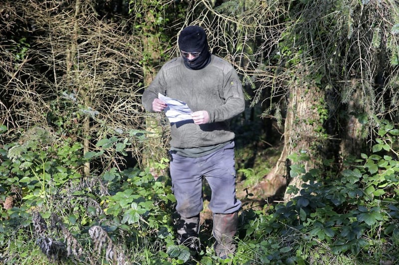 A masked man reads from a statement received by The Irish News last week threatening the directors of QIH (Quinn Industrial Holdings) 