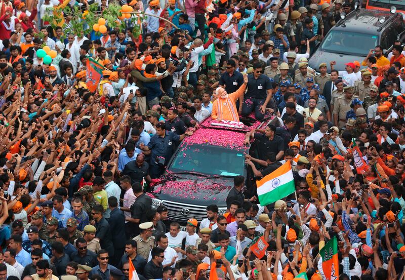 Indian Prime Minister Narendra Modi waves to the crowd during a political campaign road show in Varanasi, India (Rajesh Kumar Singh/AP)