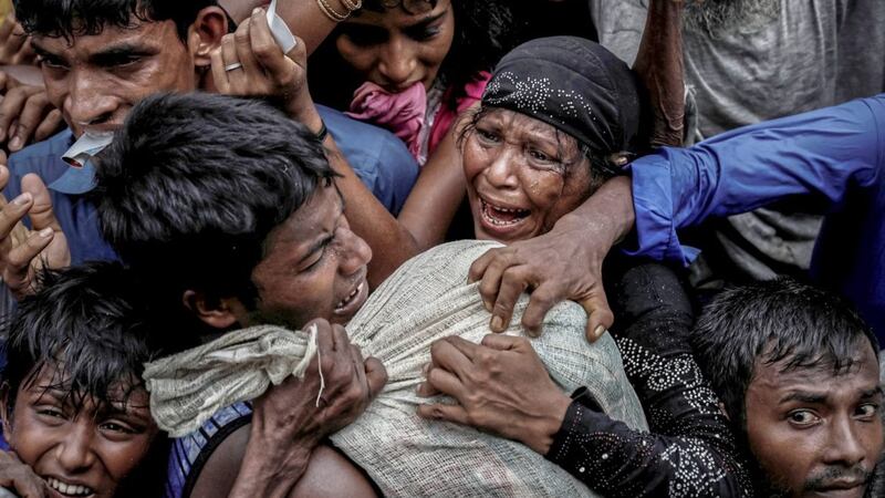 Rohingya refugees scramble for aid at a camp in Cox&#39;s Bazar, Bangladesh last year 