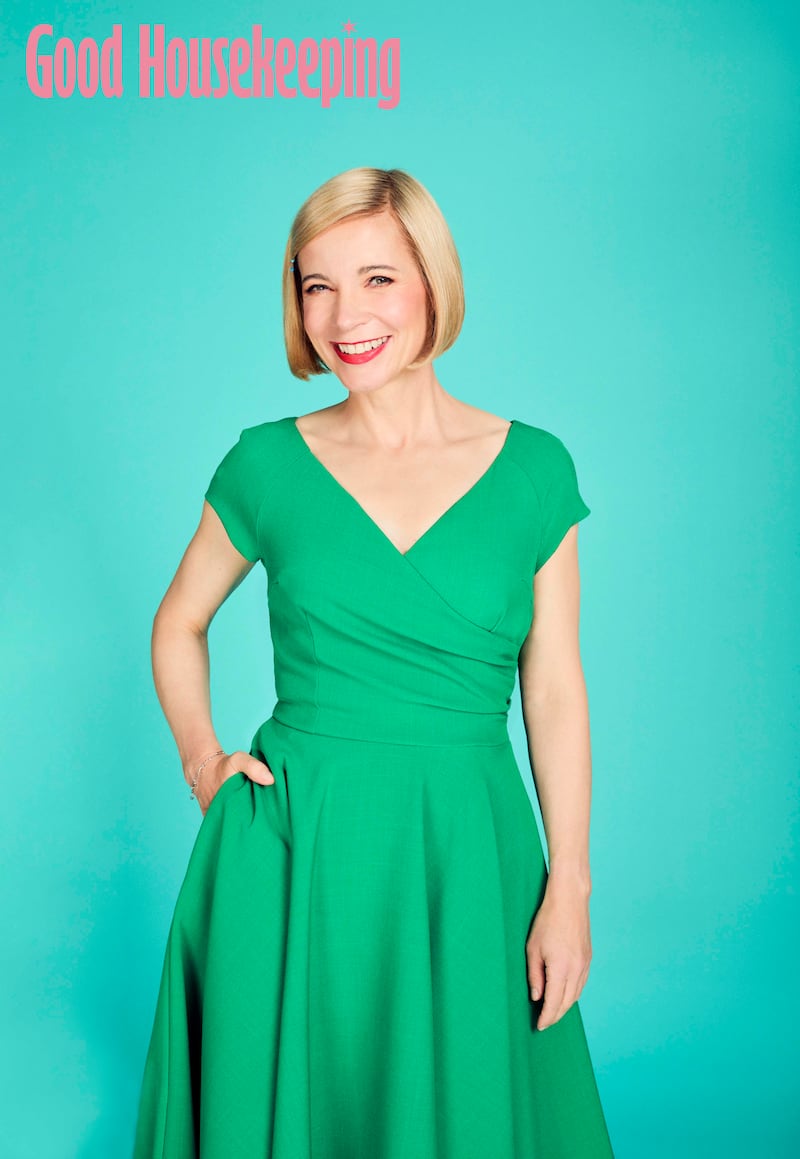 Lucy Worsley smiling, with her hand on her hip.