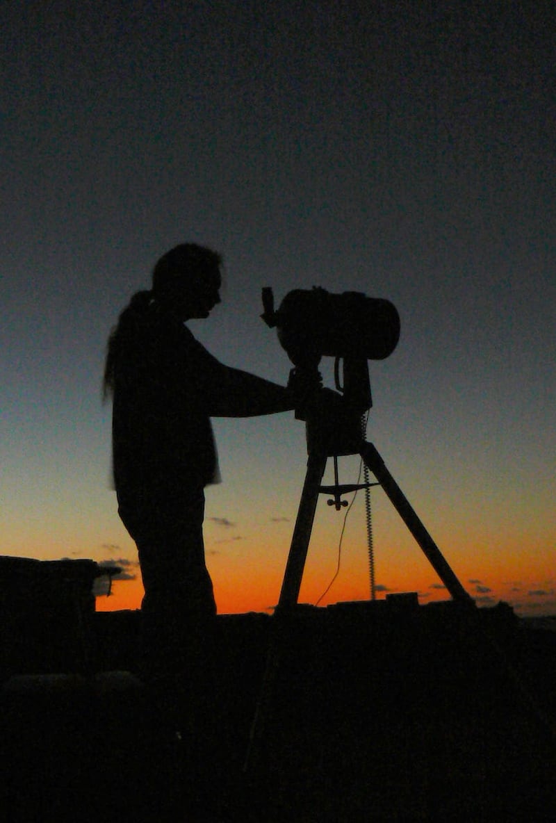 A member of Basingstoke Astronomical Society using a telescope 