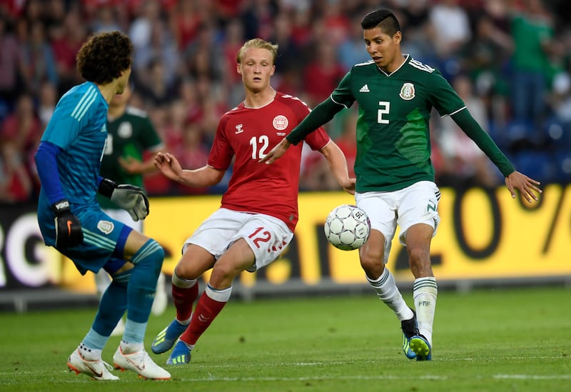 A football match between Denmark and Mexico