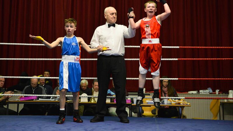 Canal's Joshua Johnston jumps for joy after having his hand raised by referee Brendan Lowe following a hard fought victory over Townland's Lee Hanna at the Antrim Boy/Girl 123 Championships. Picture by Mark Marlow