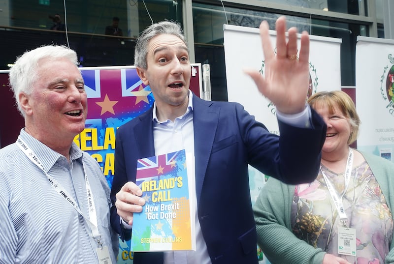 Fine Gael leader Simon Harris with author Stephen Collins, left, as he arrives at the 82nd Fine Gael ard fheis at the University of Galway