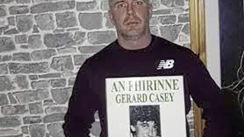 Paul Casey holds a picture of his father Gerard who was killed in1989 