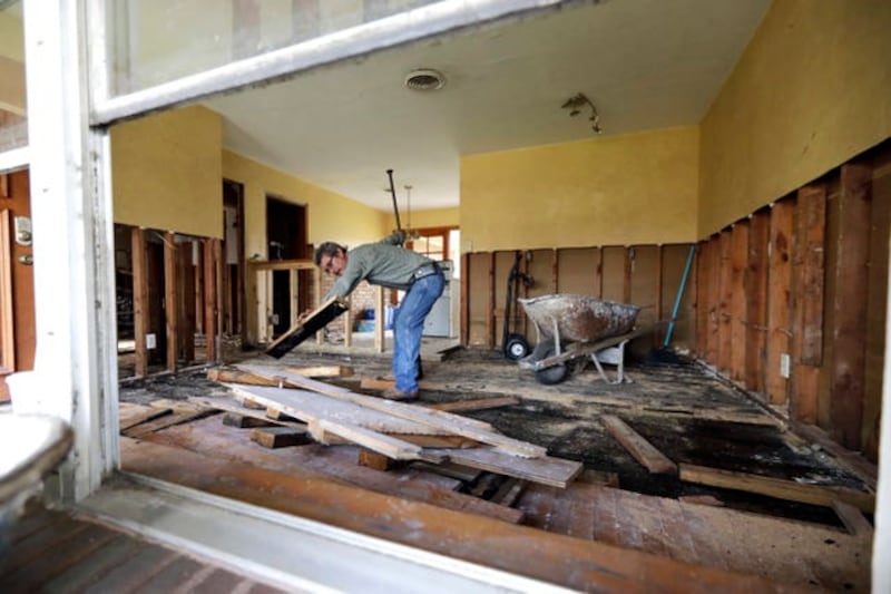 Jesus Ramirez works on his home after it was damaged in Hurricane Harvey 