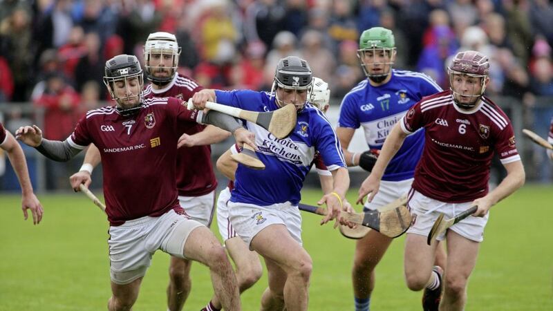 Cushendall's Eoghan Campbell and Stephen Walsh close down Conor Johnston during Sunday's semi-final replay in Dunloy.<br /> Picture: Seamus Loughran.