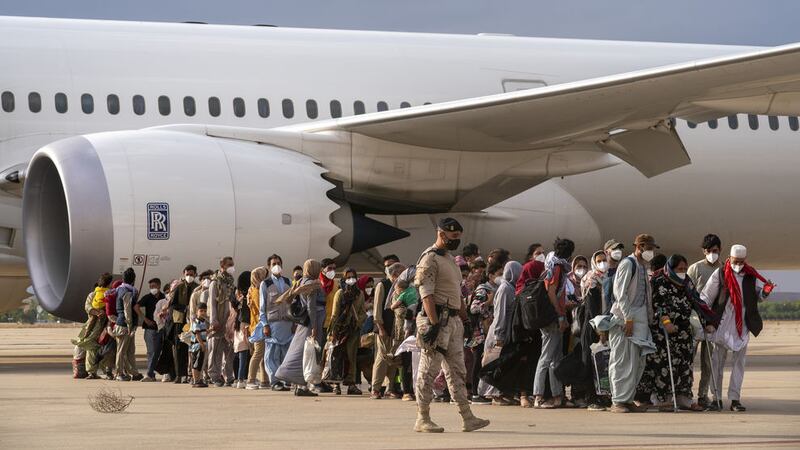 Afghan people who were transported from Afghanistan, disembarking a plane on August 23 2021, at the Torrejon military base as part of the evacuation process in Madrid. Picture by Andrea Comas, AP