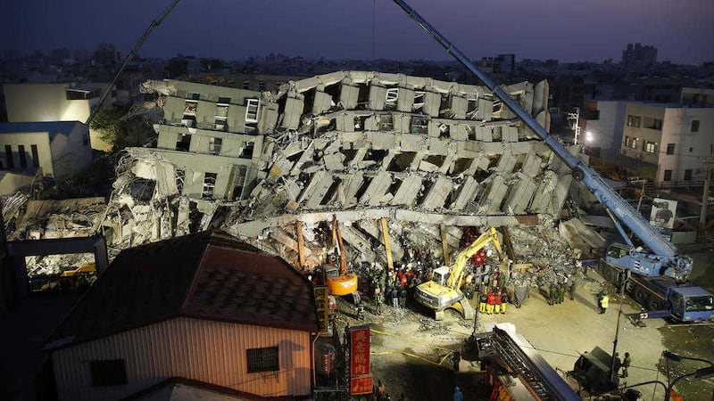 Emergency rescuers continue to search a collapsed building following a powerful earthquake. Picture by Wally Santana, Associated Press