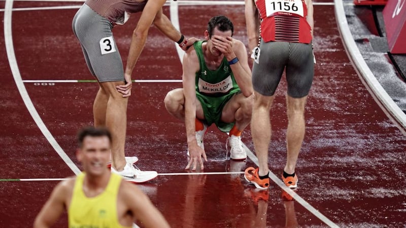 Michael McKillop (centre) of Ireland is consoled following the Men&#39;s 1500m 