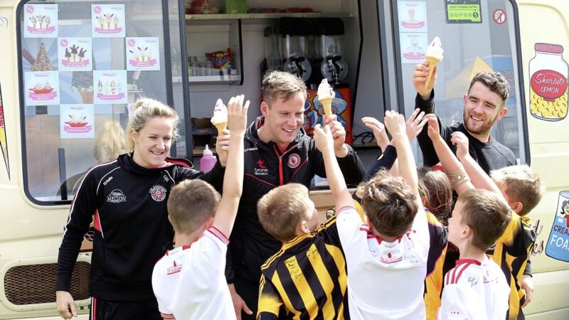 Tyrone footballers Gemma Begley, Kieran McGeary and Brendan Burns help children in Pomeroy cool down after a week&#39;s exertions at one of the county&#39;s popular GAA summer camps. Picture by Mal McCann 