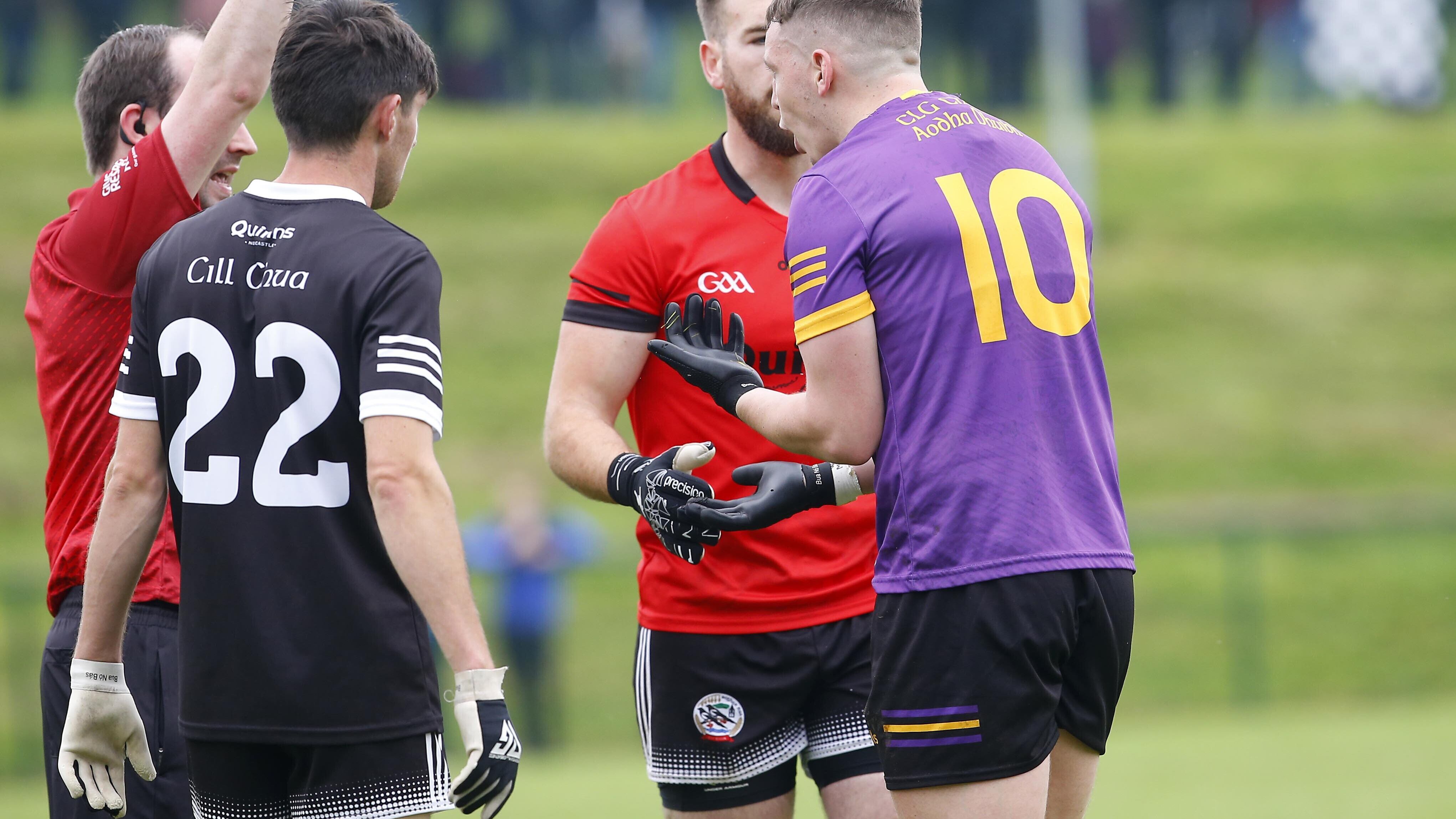 Referee Miceal Moore shows a red card to Carryduff's Cian Clinton just before half-time in Sunday's Down SFC quarter-final clash
