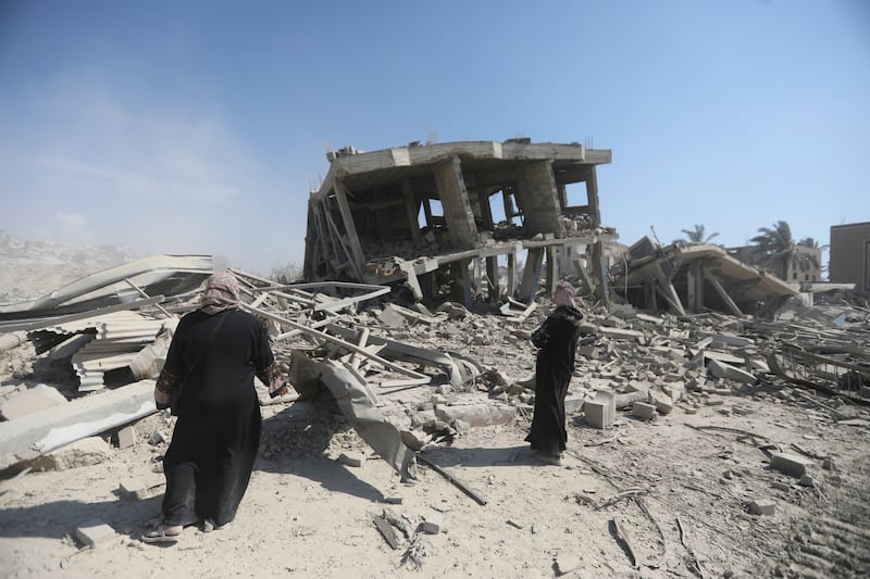 Palestinians inspect the destruction left by the Israeli air and ground offensive after they withdrew from Khan Younis, southern Gaza Strip (Ismael Abu Dayyah/AP)