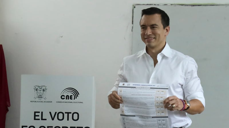 President Daniel Noboa holds the ballot during a referendum to endorse new security measures to crackdown on criminal gangs (Cesar Munoz/AP)