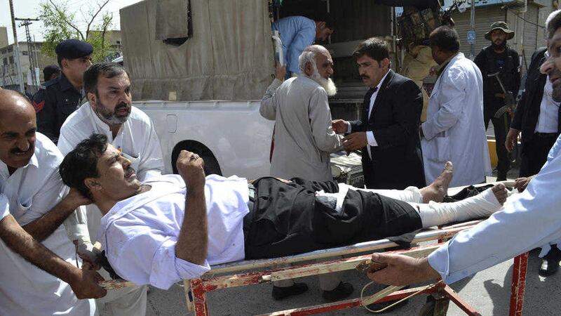 People carry an injured lawyer to a hospital in Quetta Picture Arshad Butt/AP