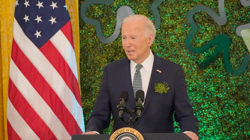 US President Joe Biden speaks during a St Patrick's Day brunch with Catholic leaders in the White House on St Patrick's Day, with the US flag behind him