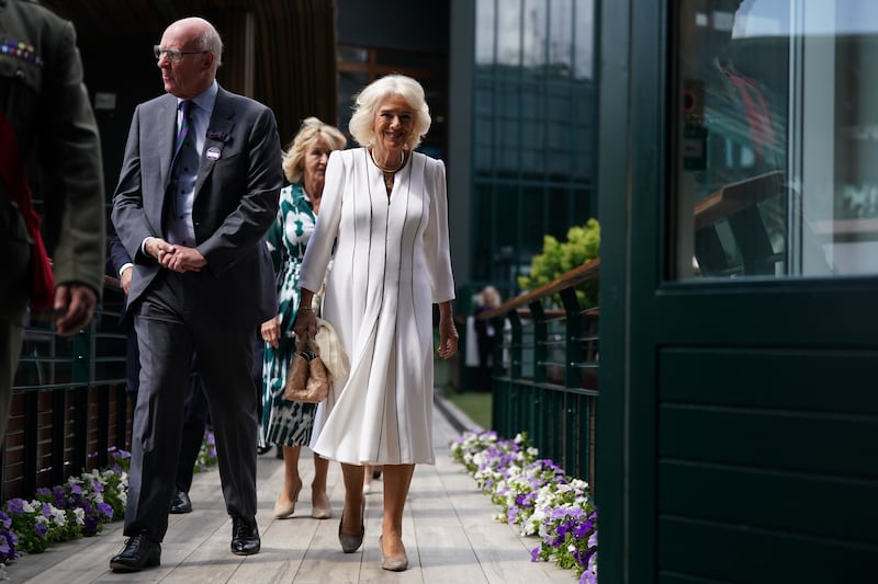 Queen Camilla with AELTC chairman, Ian Hewitt as she arrives for her visit on day ten of the 2023 Wimbledon Championships