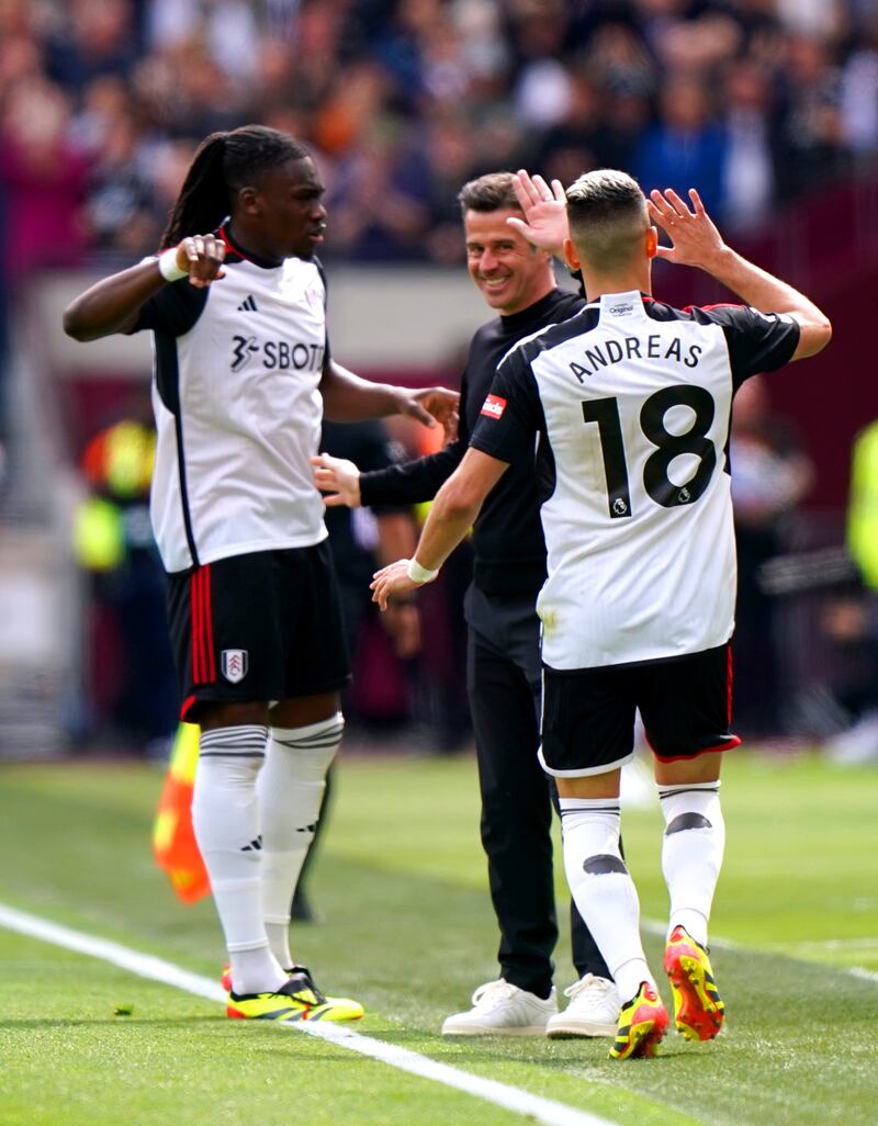 Marco Silva, centre, celebrates with Andreas Pereira, right, and Calvin Bassey after Pereira’s first goal