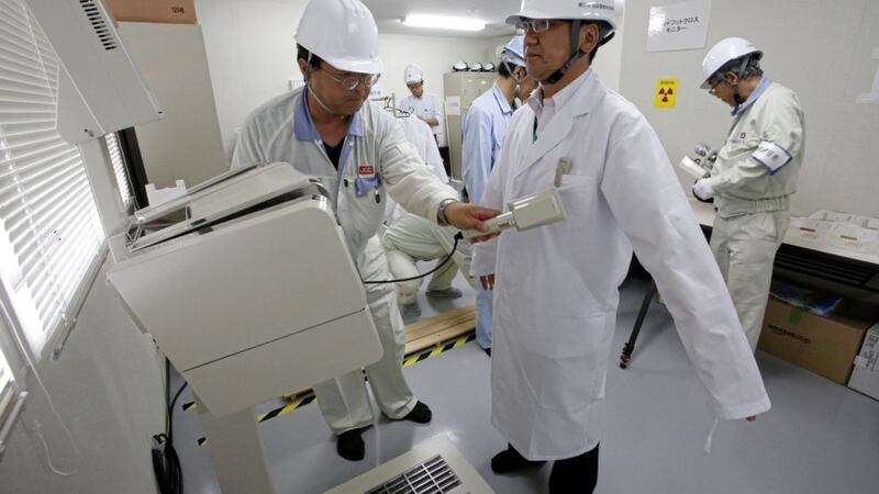 A worker is given radiation screening as he leaves the Reduction Recycling Pilot plant in Iidate, Fukushima Prefecture, northeastern Japan PICTURE: Shizuo Kambayashi/AP 