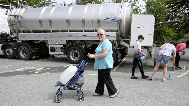People collect water from a Northern Ireland Water Tanker outside Termonfeckin national school, Drogheda, after a pipe burst. Picture by Niall Carson/Press Association 
