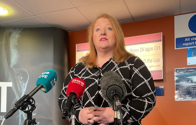Naomi speaking to reporters at a press conference at the Department of Justice at Stormont