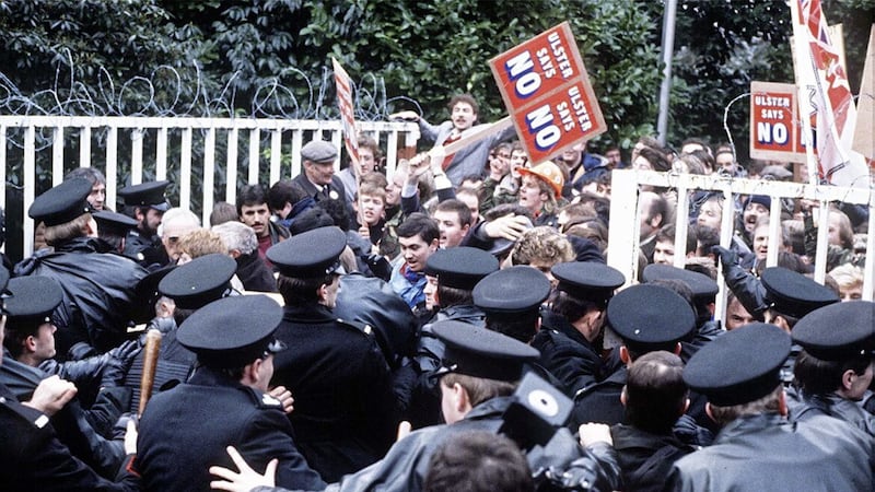 Loyalist protesters clash with RUC officers at the gates of the Maryfield Secretariat, set up as part of the Anglo-Irish Agreement in 1985. Picture: Pacemaker. 
