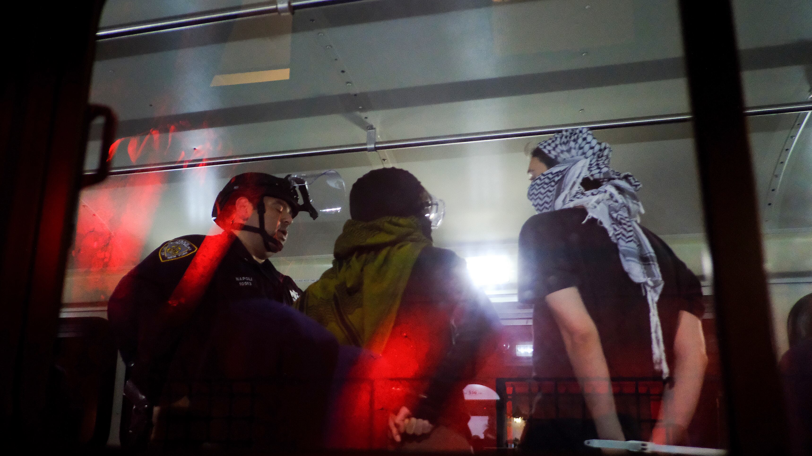 The NYPD load arrested protesters from Columbia University onto a bus (Julius Motal/AP)