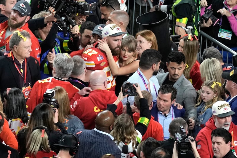 The pair are swamped by cameras and well wishers (Charlie Riedel/AP)